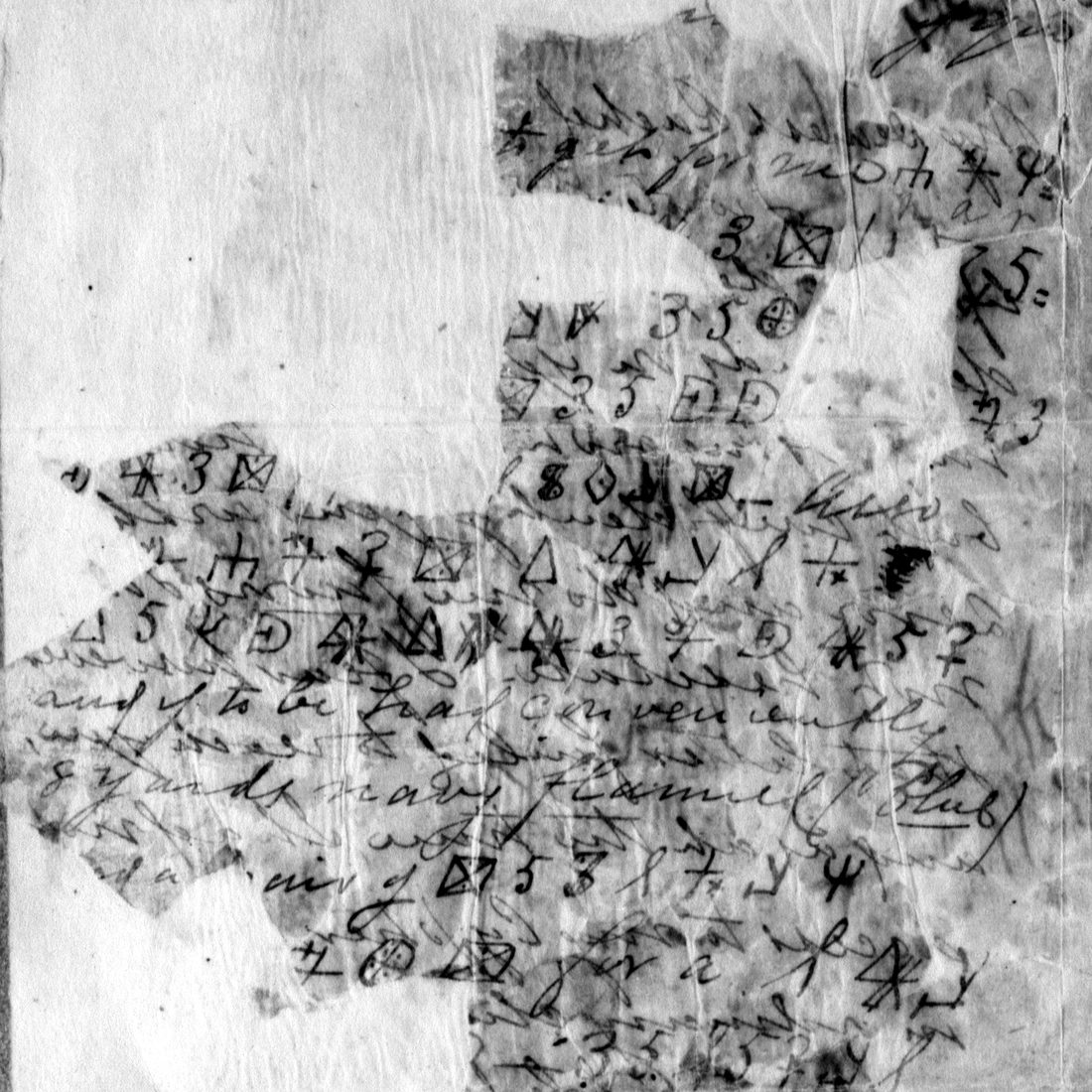 The left block of the fragment, inverted to dark writing on light: cipher groups and the clear words to be had conveniently 8 yards navy flannel
